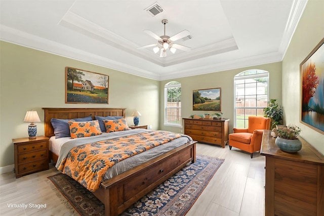 14210 Hansons Creek Ct, Houston, TX 77044 - bedroom featuring a tray ceiling, ornamental molding, light wood-type flooring, and ceiling fan