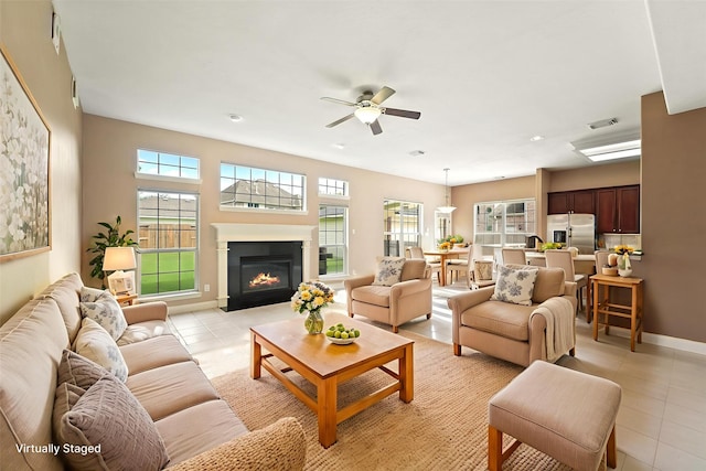14210 Hansons Creek Ct, Houston, TX 77044 - living area with light tile patterned floors, plenty of natural light, a ceiling fan, a glass covered fireplace, and recessed lighting