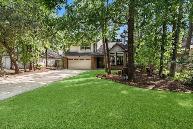 248 S Pathfinders Cir, The Woodlands, TX 77381 - view of front facade featuring brick siding, an attached garage, driveway, a front yard, and a chimney