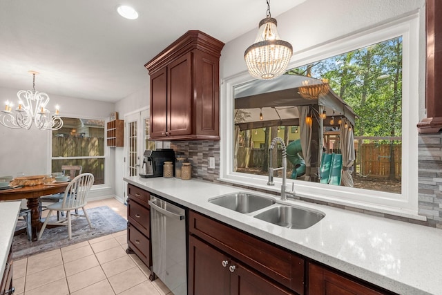 248 S Pathfinders Cir, The Woodlands, TX 77381 - kitchen with a chandelier, stainless steel dishwasher, tasteful backsplash, and decorative light fixtures