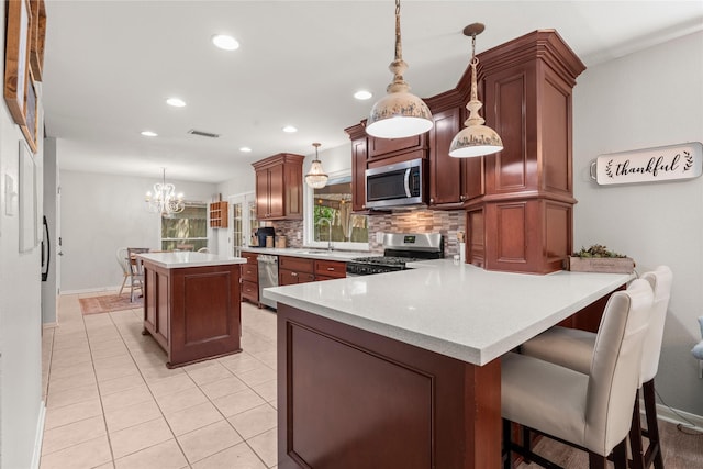 248 S Pathfinders Cir, The Woodlands, TX 77381 - kitchen with stainless steel appliances, backsplash, recessed lighting, light countertops, and a center island