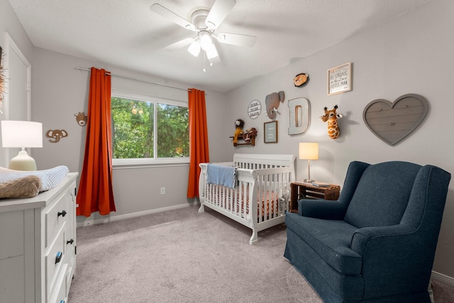 248 S Pathfinders Cir, The Woodlands, TX 77381 - carpeted bedroom featuring a crib and a ceiling fan