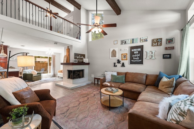 248 S Pathfinders Cir, The Woodlands, TX 77381 - living room featuring a ceiling fan, wood finished floors, healthy amount of natural light, beam ceiling, and a high ceiling