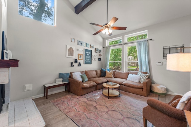 248 S Pathfinders Cir, The Woodlands, TX 77381 - living area with ceiling fan, high vaulted ceiling, beamed ceiling, a fireplace, and light wood-type flooring