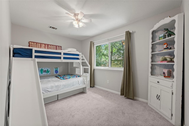 248 S Pathfinders Cir, The Woodlands, TX 77381 - bedroom with light colored carpet and ceiling fan