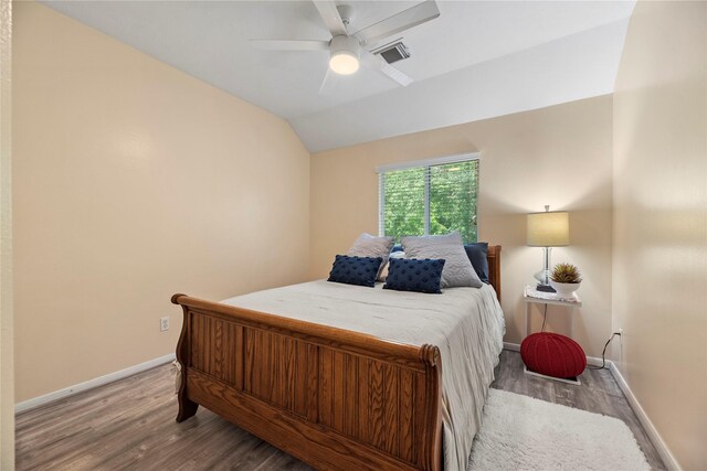 17706 Riata Lake Dr, Cypress, TX 77433 - bedroom with wood finished floors, lofted ceiling, and a ceiling fan