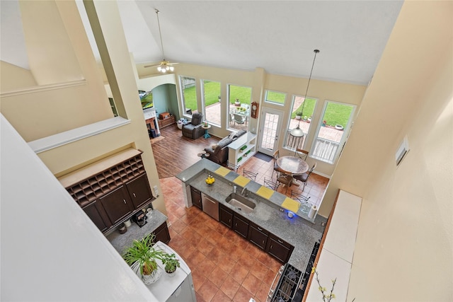 17706 Riata Lake Dr, Cypress, TX 77433 - tiled living room with high vaulted ceiling, a ceiling fan, and arched walkways