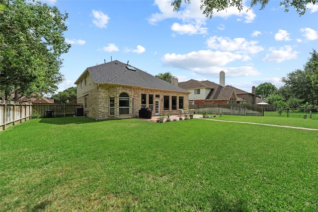 17706 Riata Lake Dr, Cypress, TX 77433 - rear view of house with brick siding, a patio, a shingled roof, and a fenced backyard