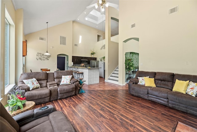 17706 Riata Lake Dr, Cypress, TX 77433 - living room with ceiling fan, high vaulted ceiling, wood finished floors, and stairs