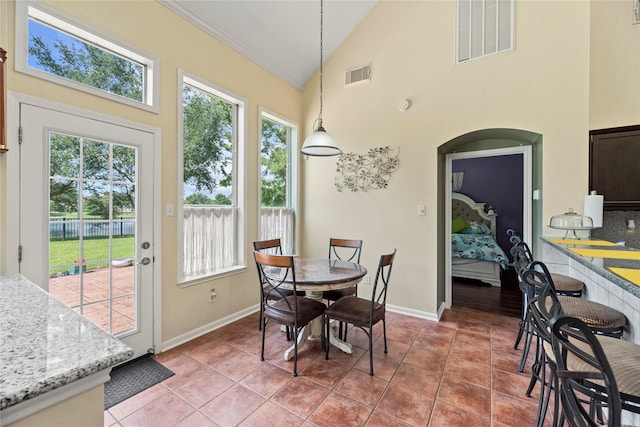 17706 Riata Lake Dr, Cypress, TX 77433 - dining area featuring plenty of natural light, high vaulted ceiling, light tile patterned flooring, and ornamental molding