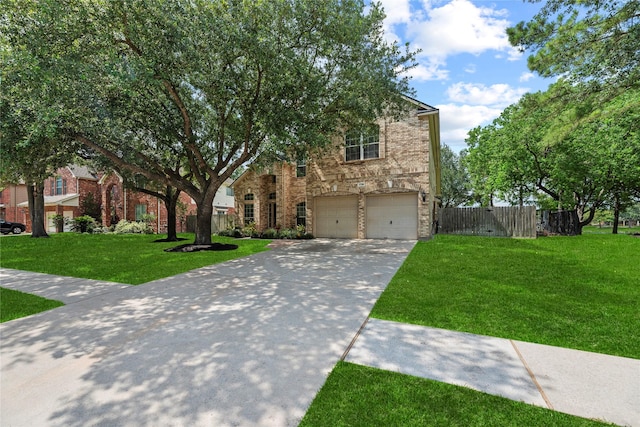 17706 Riata Lake Dr, Cypress, TX 77433 - view of front of house featuring driveway, an attached garage, stone siding, and brick siding
