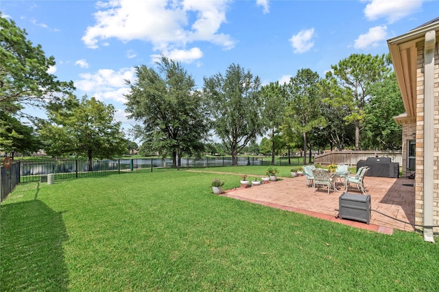 17706 Riata Lake Dr, Cypress, TX 77433 - fenced backyard with a patio and a water view