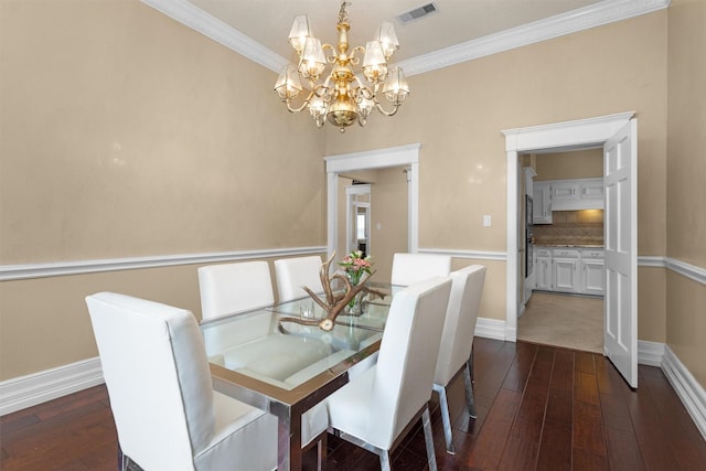 9311 Windrush Dr, Spring, TX 77379 - dining space featuring dark wood-style floors, a chandelier, and crown molding
