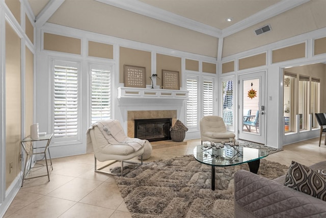 9311 Windrush Dr, Spring, TX 77379 - living area featuring light tile patterned floors, crown molding, and a tile fireplace
