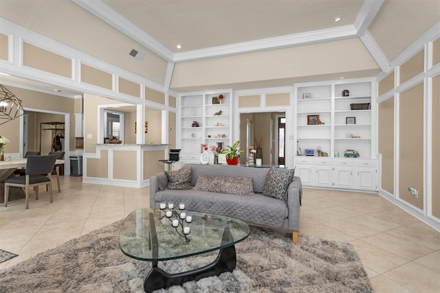 9311 Windrush Dr, Spring, TX 77379 - living room with light tile patterned floors, crown molding, built in shelves, and a towering ceiling