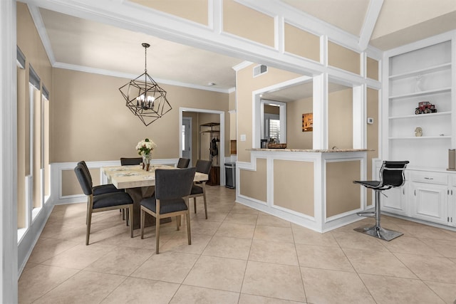 9311 Windrush Dr, Spring, TX 77379 - dining space with built in features, light tile patterned floors, a chandelier, and crown molding