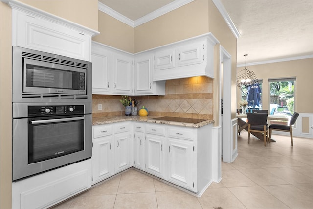 9311 Windrush Dr, Spring, TX 77379 - kitchen featuring appliances with stainless steel finishes, light tile patterned flooring, ornamental molding, decorative backsplash, and a chandelier