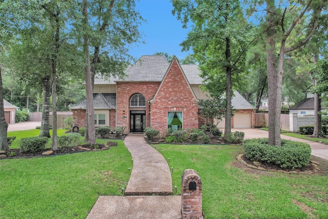 9311 Windrush Dr, Spring, TX 77379 - view of front facade featuring brick siding, roof with shingles, driveway, and french doors
