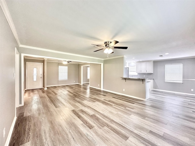 5818 Birchmont Dr, Houston, TX 77092 - unfurnished living room featuring ceiling fan, light wood-type flooring, and crown molding