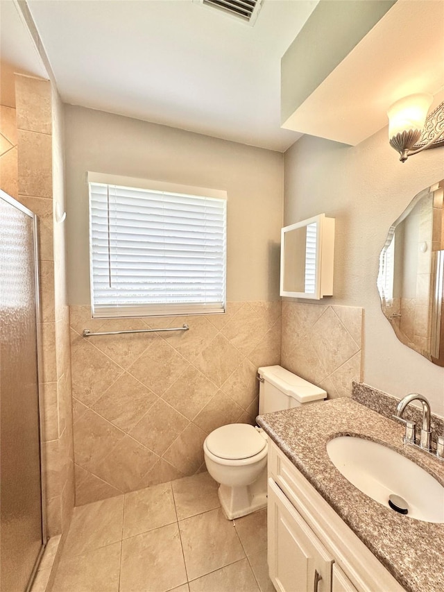 5818 Birchmont Dr, Houston, TX 77092 - bathroom with a stall shower, tile walls, tile patterned flooring, vanity, and wainscoting
