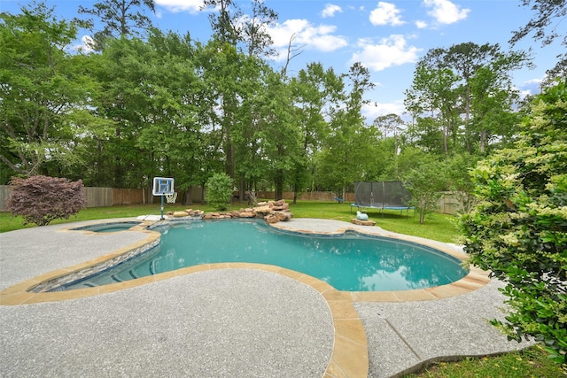 14014 Lakewood Crossing Blvd, Houston, TX 77070 - view of pool featuring a trampoline, a fenced backyard, an in-ground hot tub, a patio area, and view of scattered trees