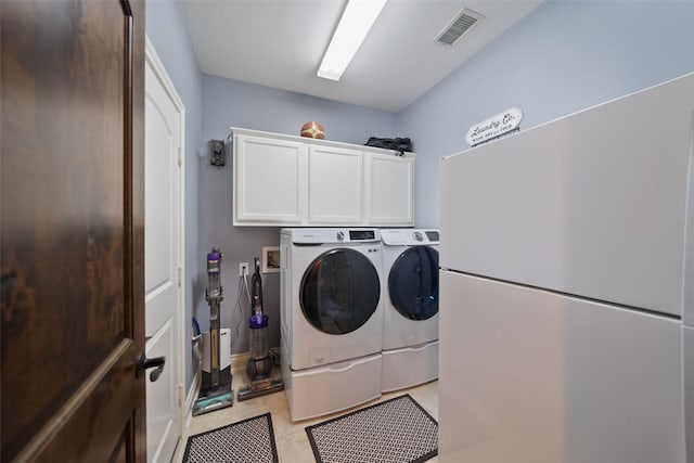 14014 Lakewood Crossing Blvd, Houston, TX 77070 - laundry room featuring cabinet space, washing machine and dryer, and light tile patterned flooring