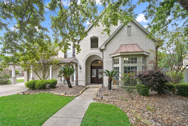 14014 Lakewood Crossing Blvd, Houston, TX 77070 - view of front of house with a front lawn, brick siding, and a standing seam roof