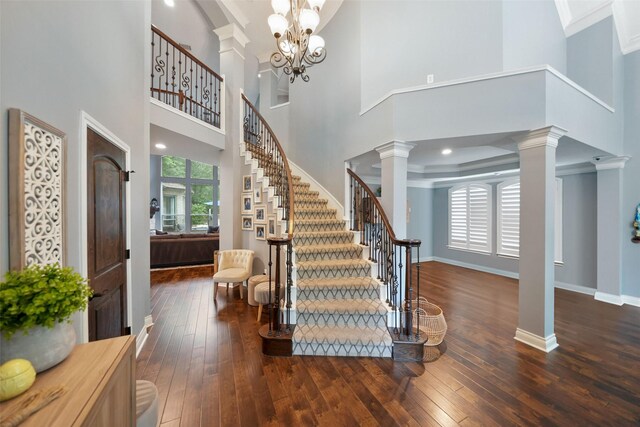 14014 Lakewood Crossing Blvd, Houston, TX 77070 - foyer with decorative columns, plenty of natural light, hardwood / wood-style floors, a towering ceiling, and ornamental molding