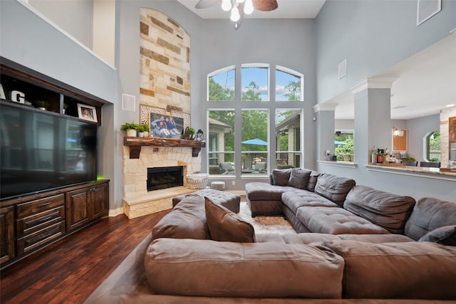14014 Lakewood Crossing Blvd, Houston, TX 77070 - living room with dark wood-style floors, a ceiling fan, a high ceiling, and a fireplace