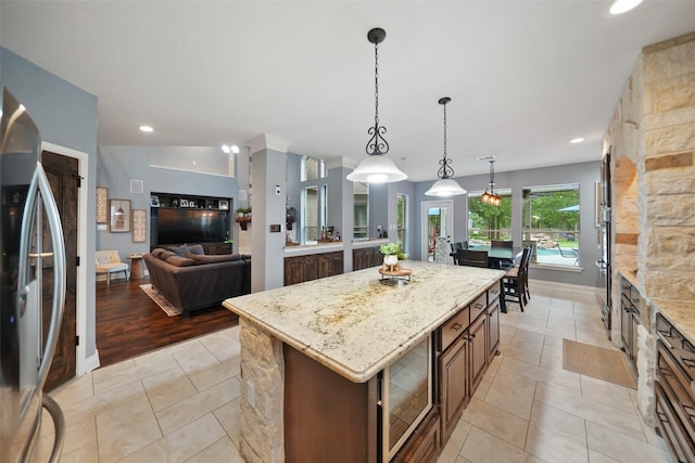 14014 Lakewood Crossing Blvd, Houston, TX 77070 - kitchen with freestanding refrigerator, light stone counters, decorative light fixtures, a center island, and recessed lighting