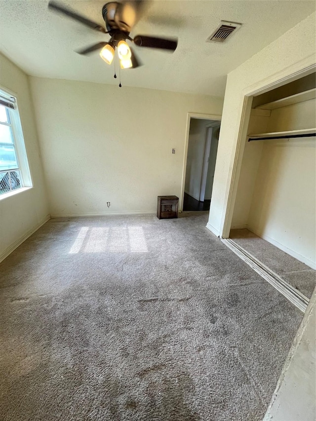 7539 Carothers St, Houston, TX 77028 - unfurnished bedroom featuring carpet, a textured ceiling, ceiling fan, and a closet