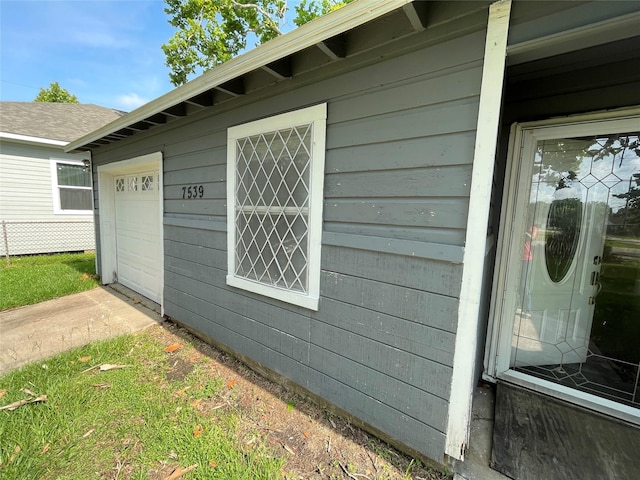 7539 Carothers St, Houston, TX 77028 - entrance to property featuring a garage and concrete driveway