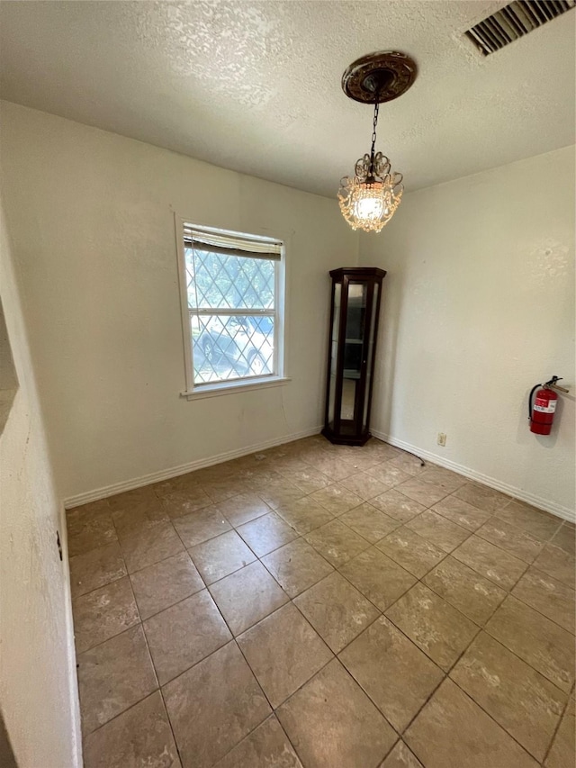 7539 Carothers St, Houston, TX 77028 - spare room with a textured ceiling and tile patterned floors
