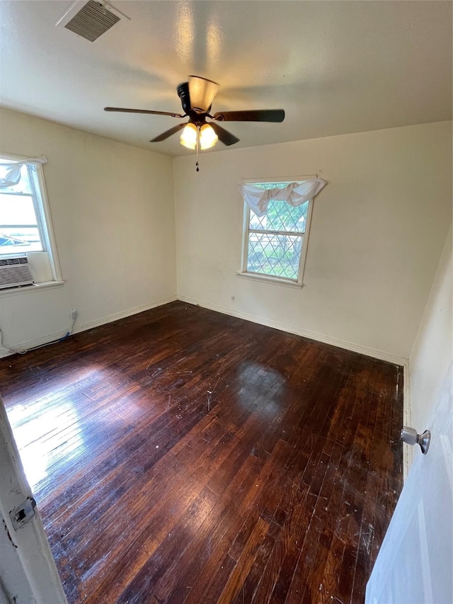 7539 Carothers St, Houston, TX 77028 - empty room with hardwood / wood-style flooring, healthy amount of natural light, a ceiling fan, and cooling unit