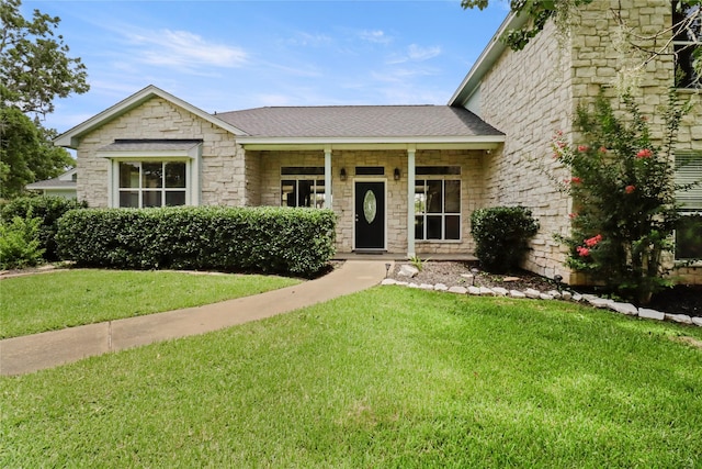 105 Sally Lake Ct, Angleton, TX 77515 - view of front of house with a front yard, stone siding, and roof with shingles