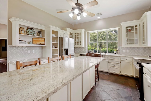 105 Sally Lake Ct, Angleton, TX 77515 - kitchen featuring stainless steel fridge, range, decorative backsplash, light stone counters, and a ceiling fan