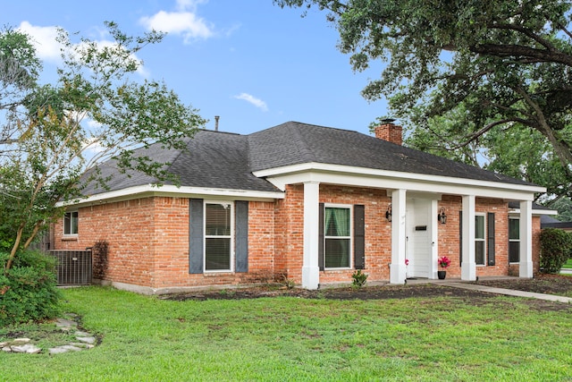 6055 Golden Forest Dr, Houston, TX 77092 - view of front of house featuring a front lawn, brick siding, a chimney, and a shingled roof