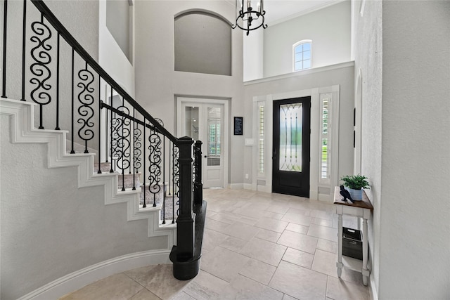 1002 Pleasant Pines Ln, Pinehurst, TX 77362 - foyer entrance featuring stairs, a textured wall, and a towering ceiling