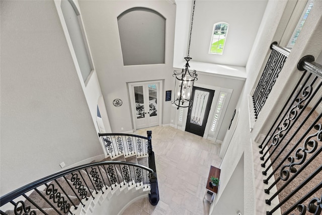 1002 Pleasant Pines Ln, Pinehurst, TX 77362 - foyer entrance with stairway, a high ceiling, plenty of natural light, french doors, and a chandelier