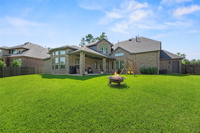 1002 Pleasant Pines Ln, Pinehurst, TX 77362 - back of house featuring an outdoor fire pit, brick siding, a fenced backyard, and a patio area