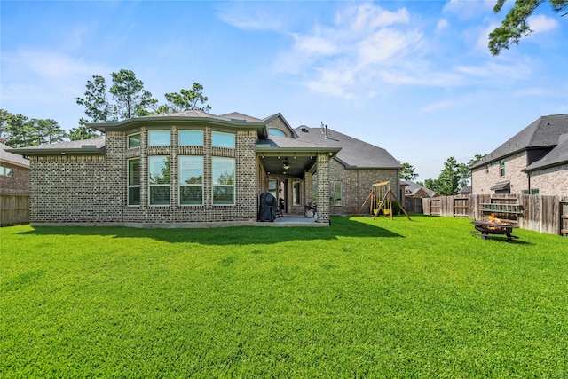 1002 Pleasant Pines Ln, Pinehurst, TX 77362 - back of property with a fenced backyard, brick siding, an outdoor fire pit, and a patio area