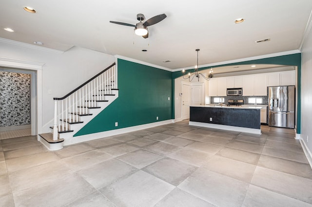 2919 Gillespie St, Houston, TX 77020 - kitchen featuring stainless steel appliances, crown molding, ceiling fan, white cabinetry, and a center island with sink