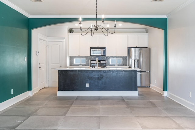 2919 Gillespie St, Houston, TX 77020 - kitchen with stainless steel appliances, crown molding, arched walkways, a kitchen island with sink, and white cabinets