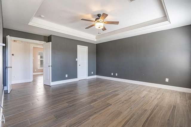 2919 Gillespie St, Houston, TX 77020 - unfurnished bedroom featuring a tray ceiling, dark wood finished floors, and ceiling fan