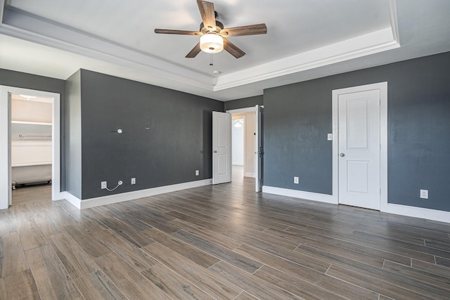 2919 Gillespie St, Houston, TX 77020 - unfurnished bedroom featuring a raised ceiling, dark wood finished floors, and ceiling fan