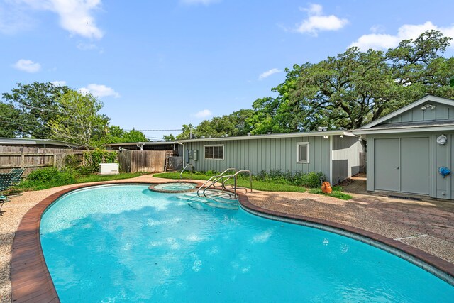 1908 Milam St, Columbus, TX 78934 - view of swimming pool featuring a pool with connected hot tub, a patio, and a shed