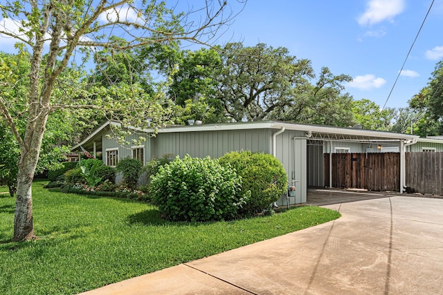 1908 Milam St, Columbus, TX 78934 - view of side of home with driveway and an attached carport
