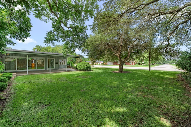 1908 Milam St, Columbus, TX 78934 - view of green lawn with a patio area
