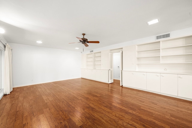 1908 Milam St, Columbus, TX 78934 - unfurnished living room with ceiling fan, wood-type flooring, built in shelves, and recessed lighting