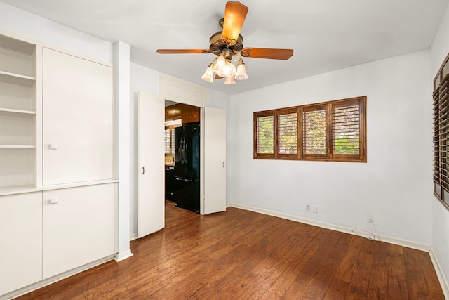 1908 Milam St, Columbus, TX 78934 - unfurnished bedroom with freestanding refrigerator, hardwood / wood-style flooring, and a ceiling fan